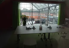 A glimpse from one of the offices to the production greenhouse.
